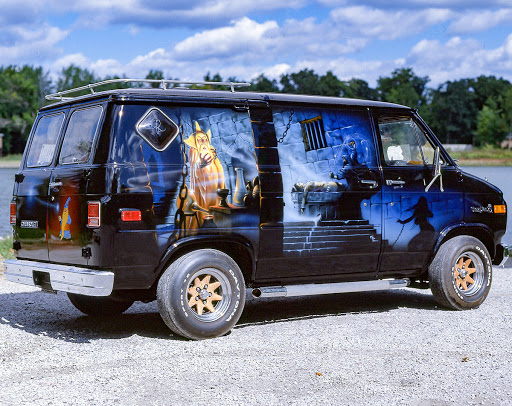 Image of a classic "wizard van" with painted fantasy-themed mural on the side